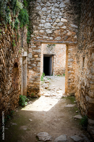 Fototapeta Naklejka Na Ścianę i Meble -  Light and shadows on entrance of a stone corridor in ancient castle,Greece