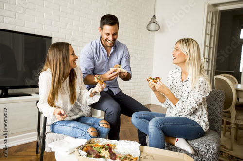 Young friends eating pizza ...