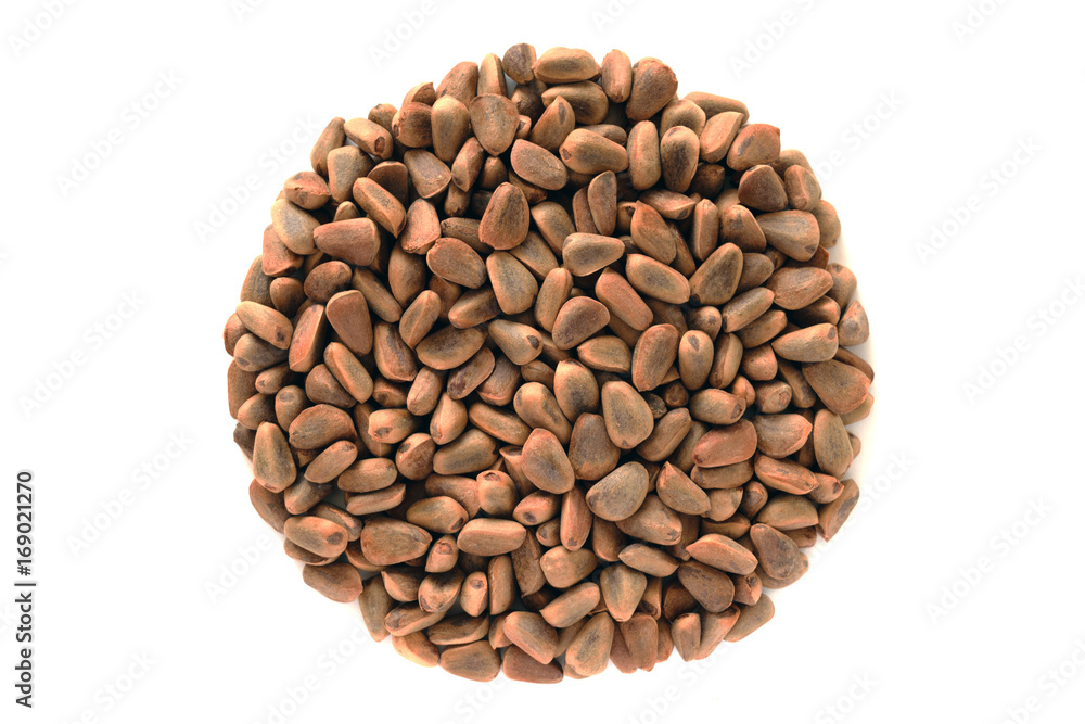 Circle shaped heap of brown Korean cedar nuts isolated on white background. Circle shaped heap of brown Korean cedar nuts isolated on white background.
