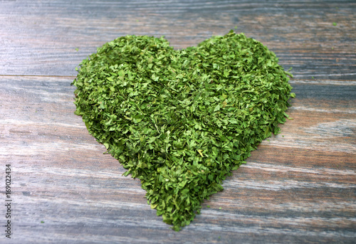 Various forms of parsley on a wooden background
