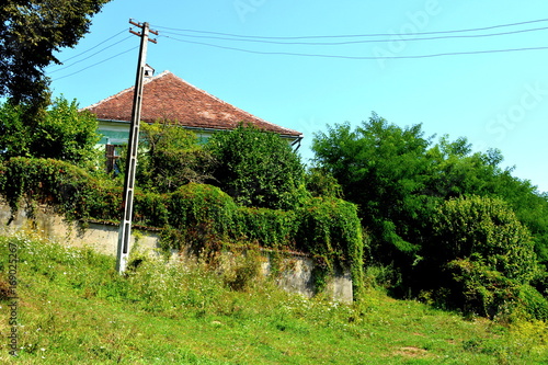 Storks. Typical rural landscape and peasant houses in  the village Somartin, Märtelsberg, Transylvania, Romania. The settlement was founded by the Saxon colonists in the middle of the 12th century photo