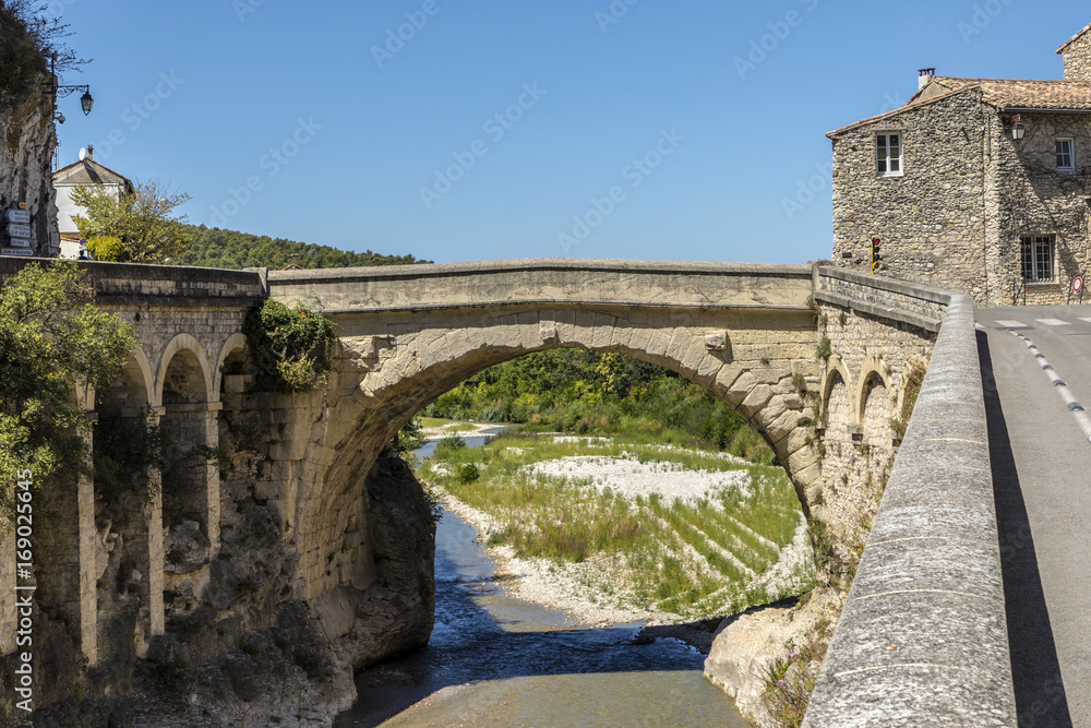 roman bridge and old town in vaison la romaine