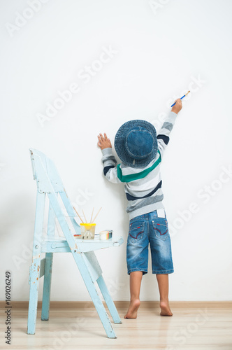 Happy child paints with paint.