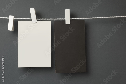 Cards hanging with the clothespins, isolated on grey