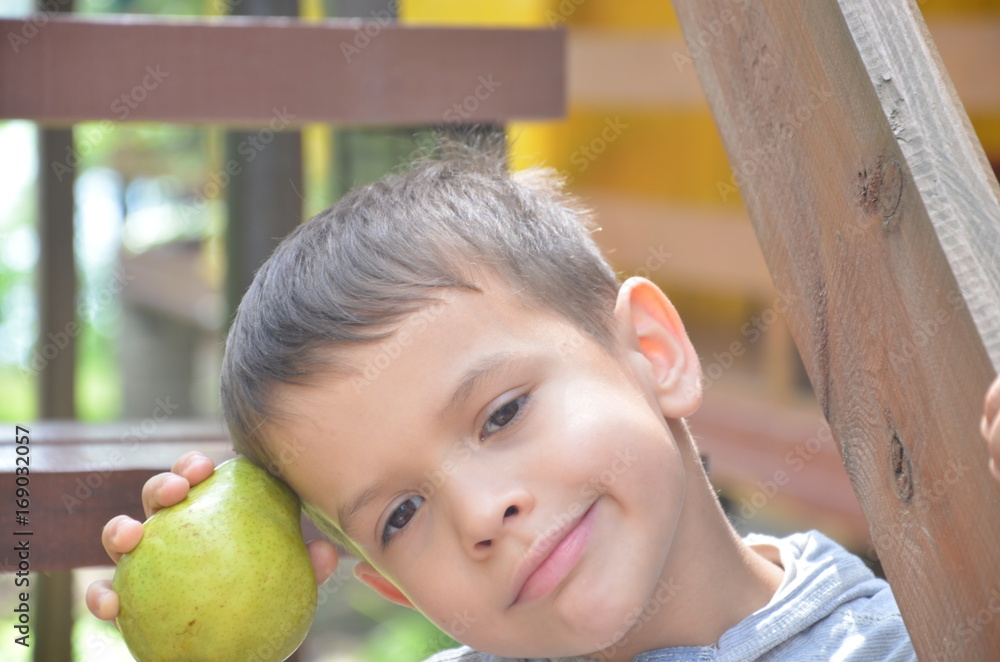 Little kid holding fresh fruits on country background Little kid holding fresh fruits on white background. Little kid holding fresh fruits on country background Little kid holding fresh fruits on white background.