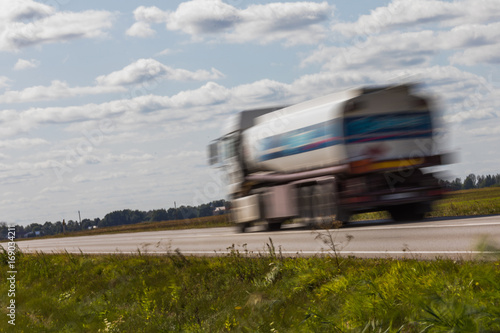 Truck transport on the road with motion blur. Blurred image background. Colorful wallpaper with copy space