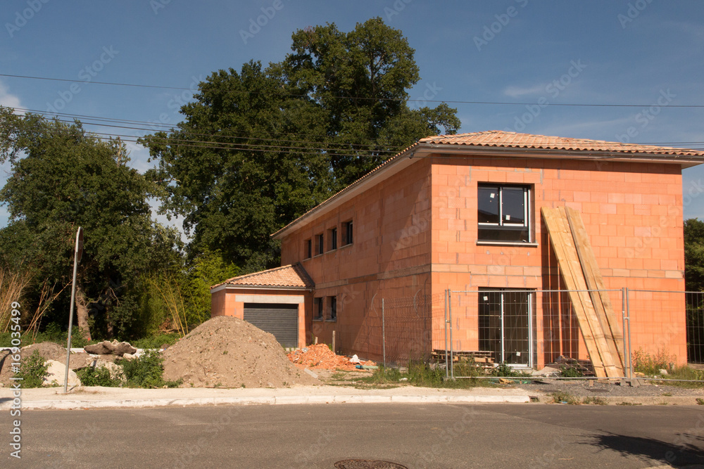 exterior of a house under construction with red brick walls exterior of a house under construction with red brick walls