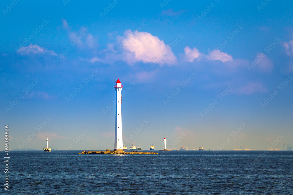 Lighthouses at sea. White lighthouse. The lighthouse on the horizon. Navigation for ships.
