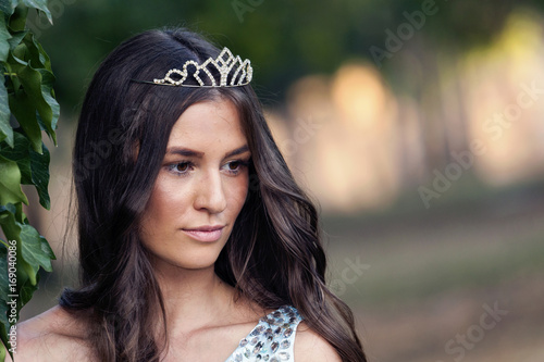 Beautiful young woman with a crown on her head
