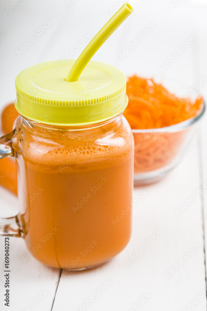 Carrot juice on a wooden table Carrot juice on a wooden table