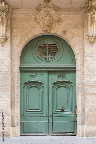     Paris  beautiful wooden green door  girder with sculptures 