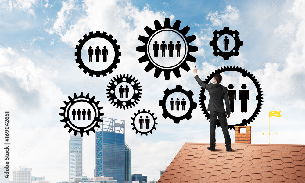Businessman on house roof presenting teamwork and connection concept. Mixed media Businessman on house roof presenting teamwork and connection concept. Mixed media