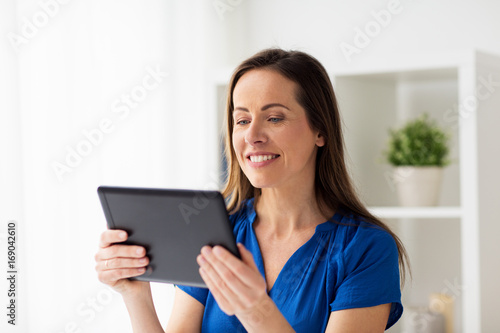 woman with tablet pc working at home or office