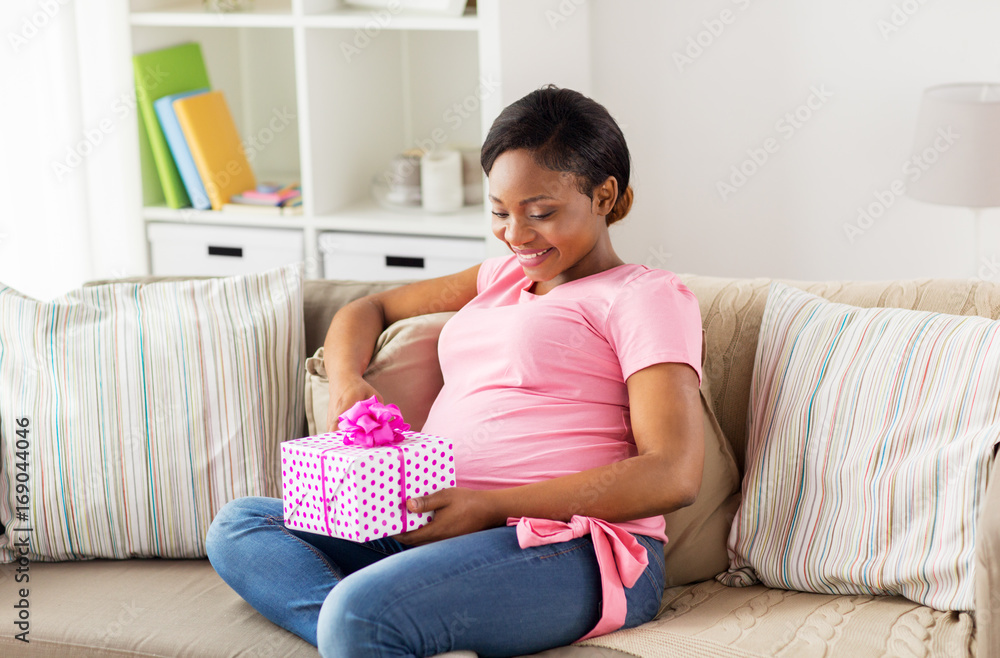 happy african american pregnant woman with gift