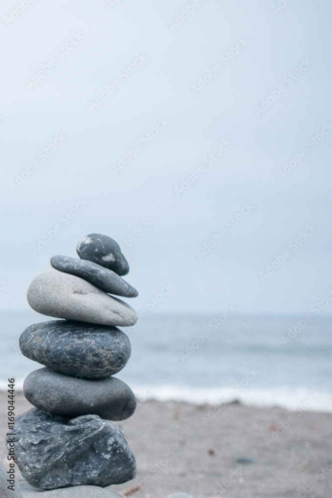 Monochrome, Serene, Blue Stacked rocks on a California beach symbolizing Peace, Balance, Meditation, and Mindfulness with Room for Copy