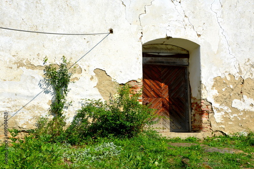 Ruins. Fortified medieval saxon evangelic church in the village Cobor, Transylvania, Romania. The settlement was founded by the Saxon colonists in the middle of the 12th century photo