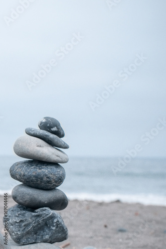 Monochrome  Serene  Blue Stacked rocks on a California beach symbolizing Peace  Balance  Meditation  and Mindfulness with Room for Copy