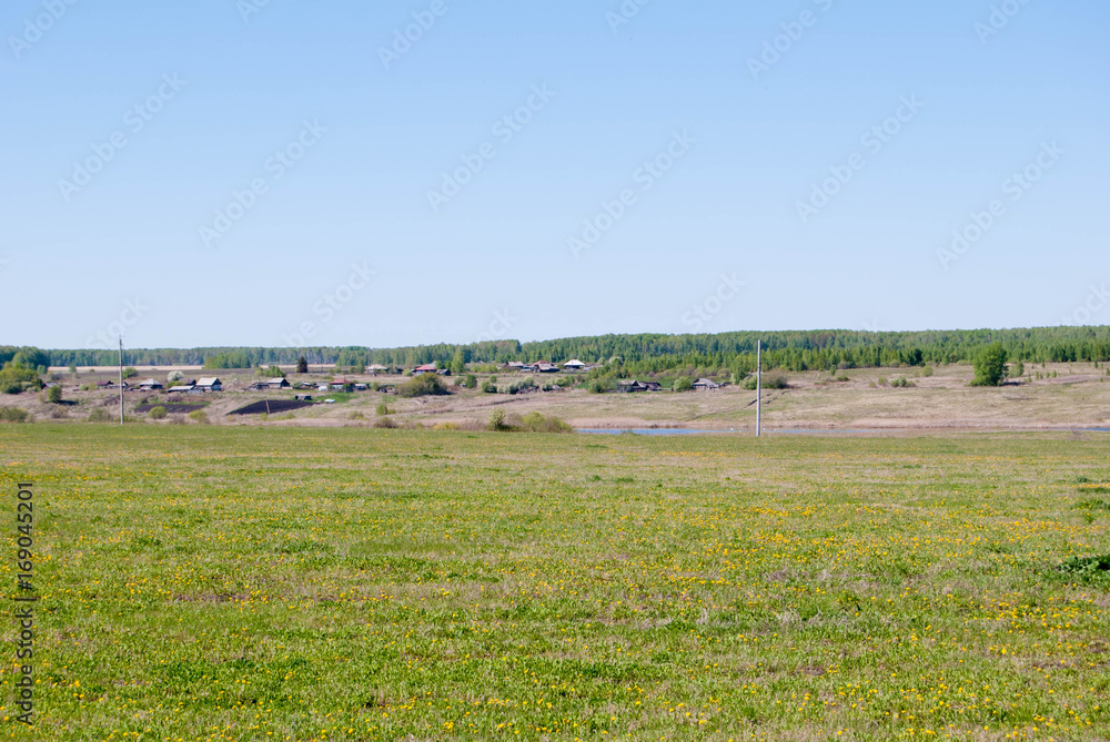 View to the Urals traditional Village and field, early spring, Sverdlovsk oblast, Russia