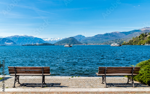 Landscape of Lake Maggiore with two benches on the shore in the foreground, Italy © EleSi
