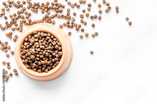 large bowl of pet - dog food spilling on white background top view mockup