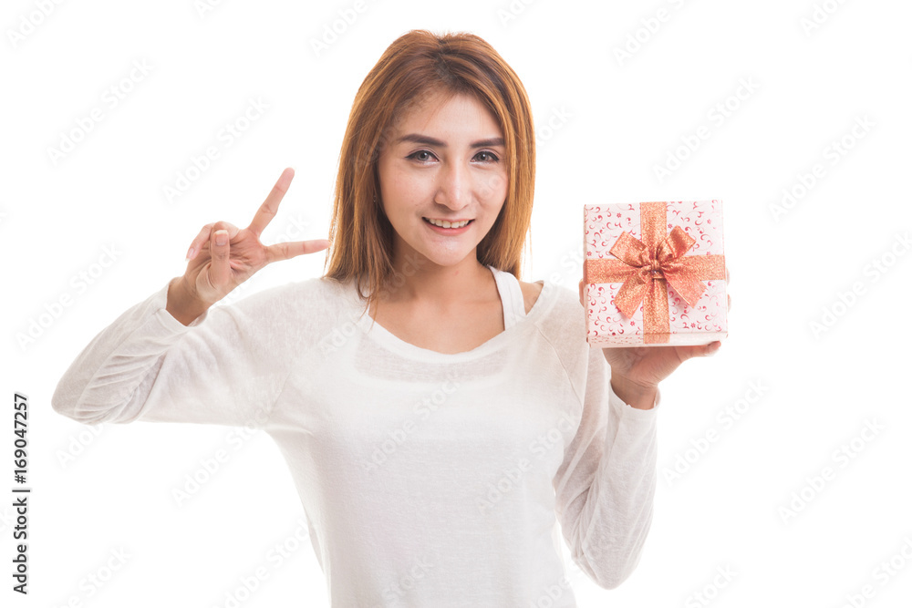 Young Asian woman show Victory sign with a gift box. Young Asian woman show Victory sign with a gift box.