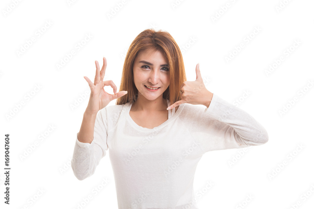 Young Asian woman show with phone gesture and OK sign. Young Asian woman show with phone gesture and OK sign.