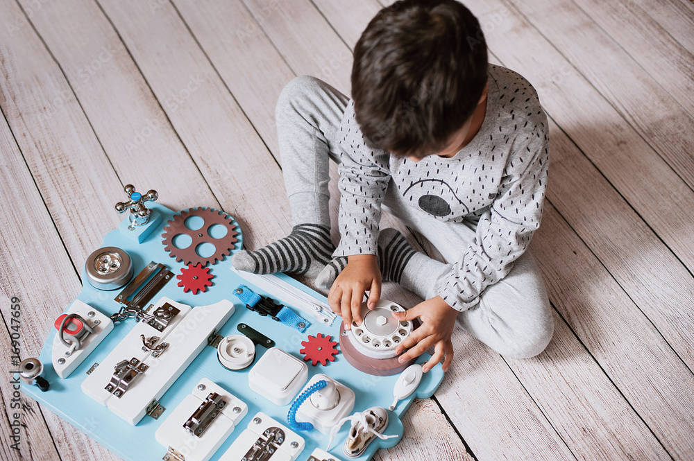 cute toddler baby playing with busy board at home cute toddler baby playing with busy board at home