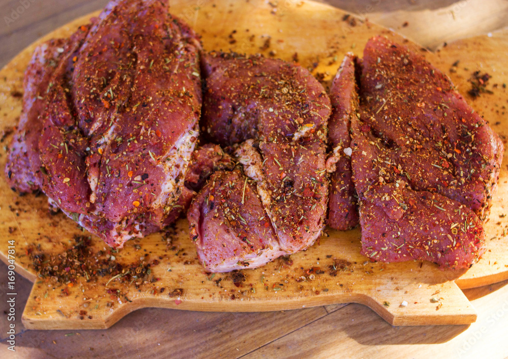 Obraz premium Raw meat with seasoning on the tree