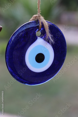 A glass turkish eye hanging by string