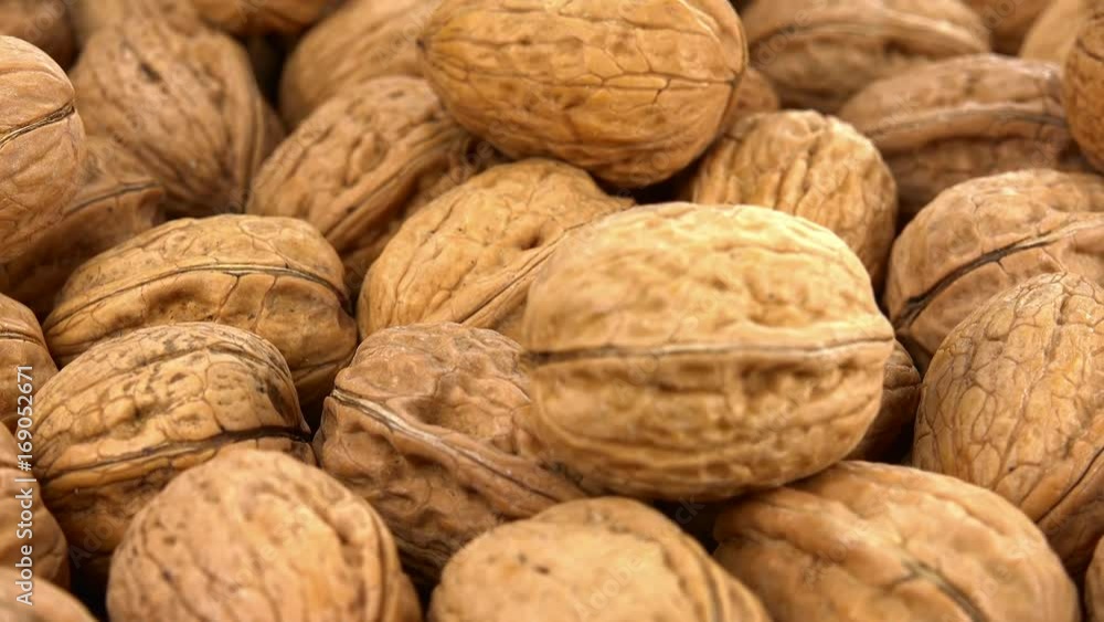 Portion of Walnuts rotating on a wooden plate (not loopale; 4K) Portion of Walnuts rotating on a wooden plate (not loopale; 4K)