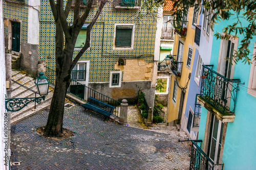 Fototapeta Naklejka Na Ścianę i Meble -  Street and cobblestone floor in the old neighborhood of Alfama, Lisbon, capital of Portugal