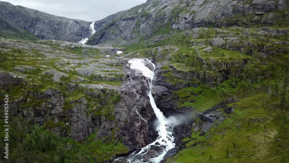 Waterfall in mountains of Norway in rainy weather from air view from drone Waterfall in mountains of Norway in rainy weather from air view from drone