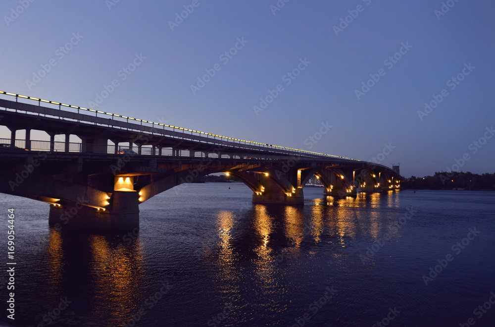 Kyiv. Ukraine. Metro Bridge over Dnieper River at dusk. Toned image.