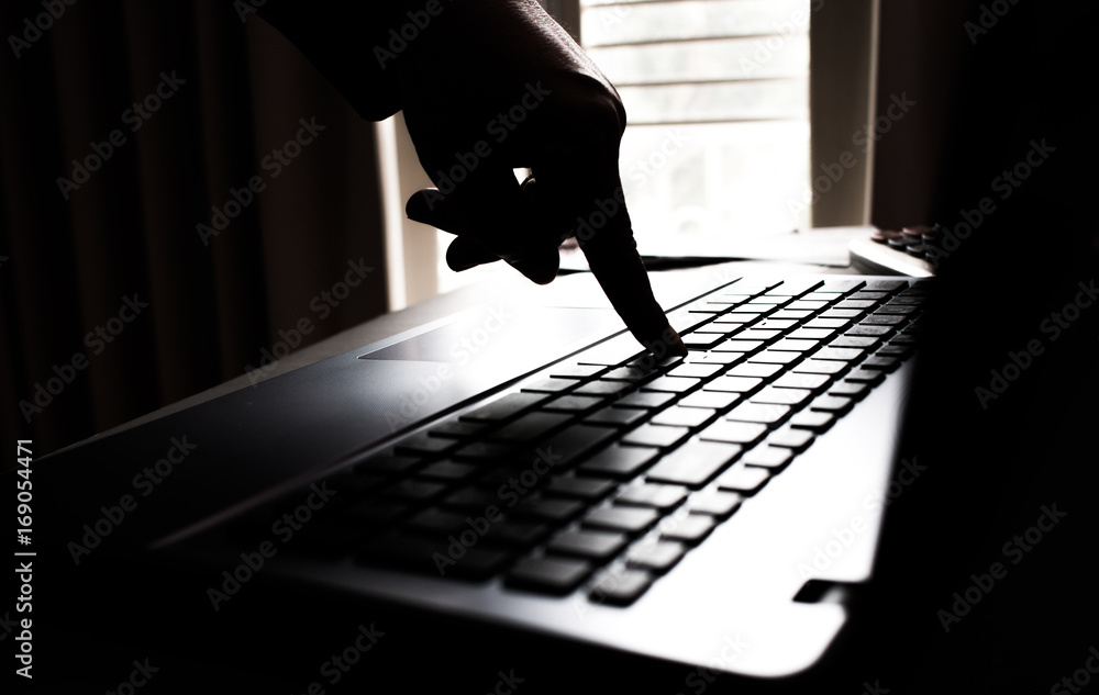 Silhouette black and white hands of anonymous hackers typing code on  keyboard of laptop for remotely reach and receiving personal information  online networking, Internet Crime Payment Security Concept Stock Photo |  Adobe