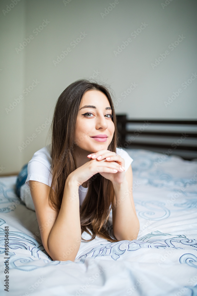 Portrait of a dreaming beautiful young woman lying on bed Portrait of a dreaming beautiful young woman lying on bed
