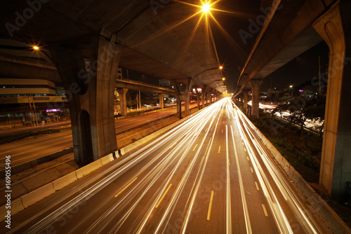 Light trails of fast moving Cars in the City and on the Expressway at midnight