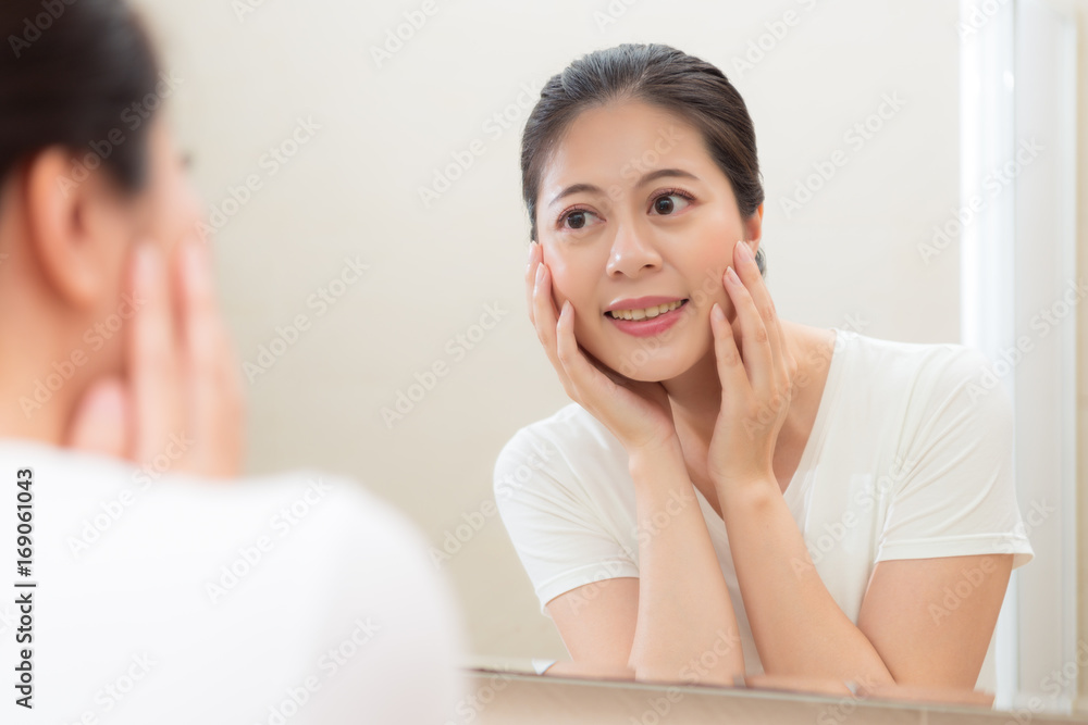 lady standing in bathroom and looking at mirror lady standing in bathroom and looking at mirror