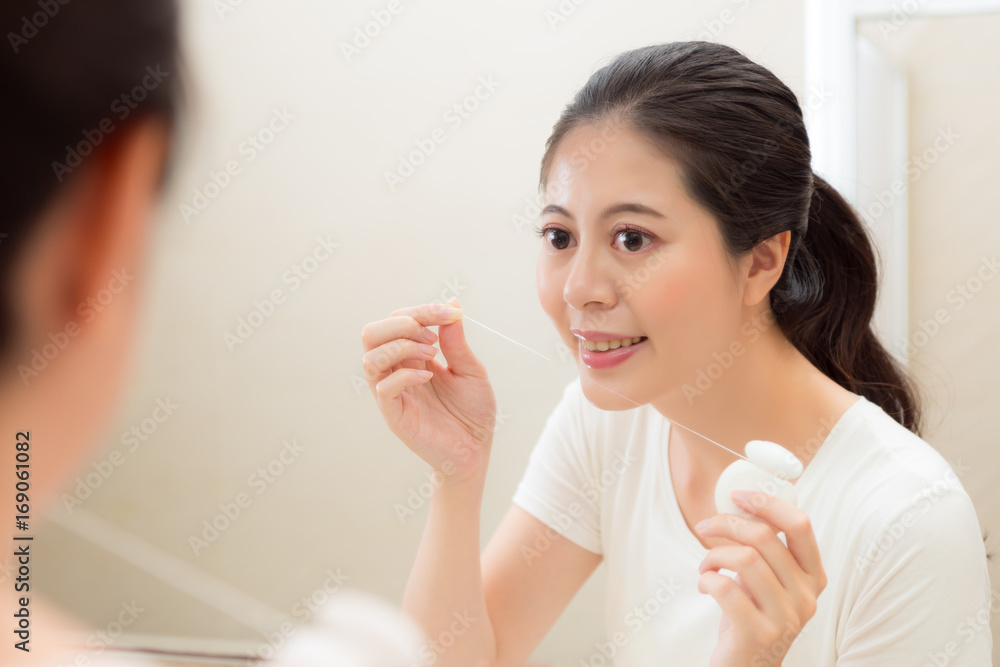 beautiful sweet female student using floss beautiful sweet female student using floss