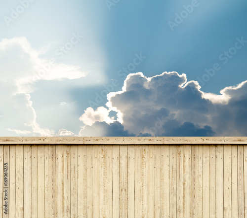wooden fence sky clouds