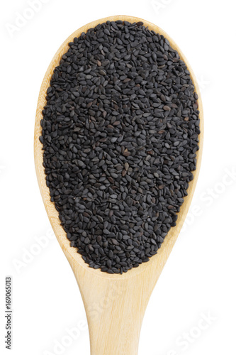 black sesame in wooden spoon isolated on white background