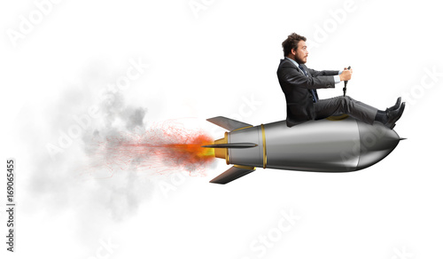 Obraz na płótnie Businessman flying over a rocket. concept of company startup