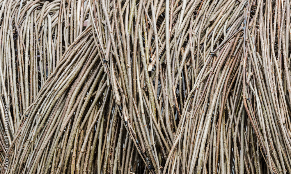 dry twig fence as textured background. natural material backdrop surface. dry twig fence as textured background. natural material backdrop surface.