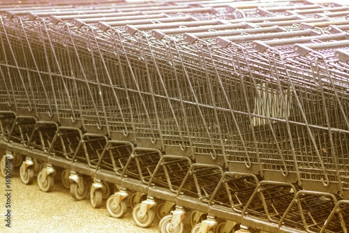 Row of shopping trolleys prepare in the supermarket.