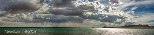 panoramic view of seascape with mountain hills at cloudy day 