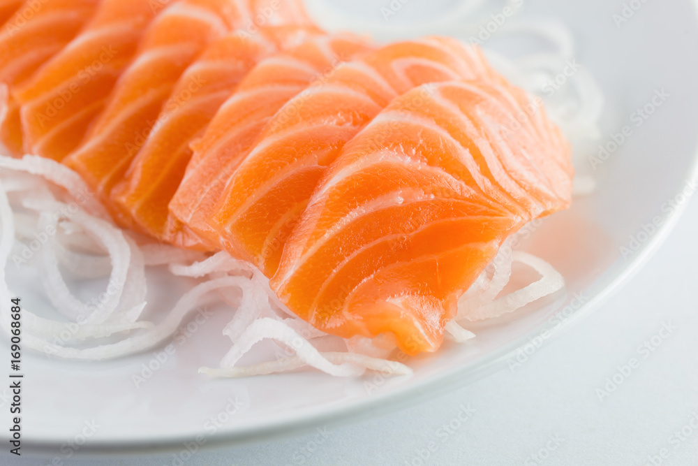 salmon sashimi, raw on a plate on a white background salmon sashimi, raw on a plate on a white background