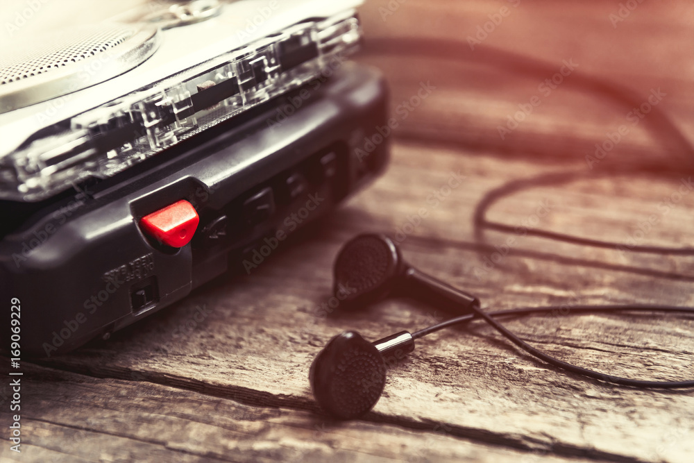 Foto de Vintage walkman cassette player with earbuds and tape cassette do  Stock | Adobe Stock