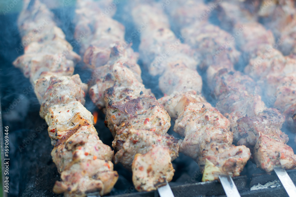 Meat with seasoning cooked on a barbecue with a haze, close up Meat with seasoning cooked on a barbecue with a haze, close up