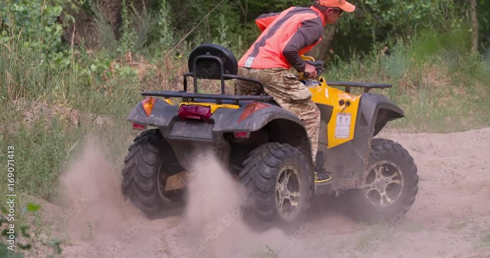 Man driving quad bike HD slow-motion video. All-terrain vehicle riding ATV in forest. Four-wheeler quadricycle transport and extreme sport. Man driving quad bike HD slow-motion video. All-terrain vehicle riding ATV in forest. Four-wheeler quadricycle transport and extreme sport.