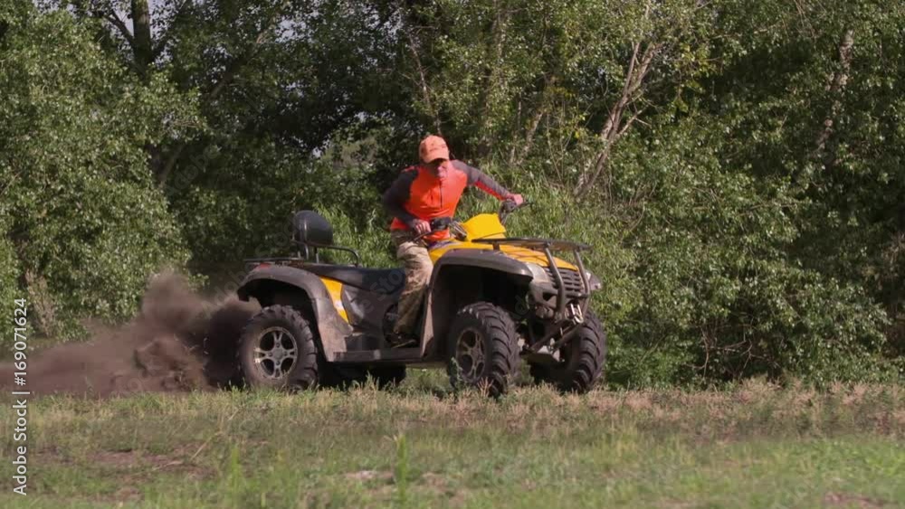 Man driving quad bike HD slow-motion video. All-terrain vehicle riding ATV on turn in forest. Four-wheeler quadricycle transport and extreme sport. Man driving quad bike HD slow-motion video. All-terrain vehicle riding ATV on turn in forest. Four-wheeler quadricycle transport and extreme sport.