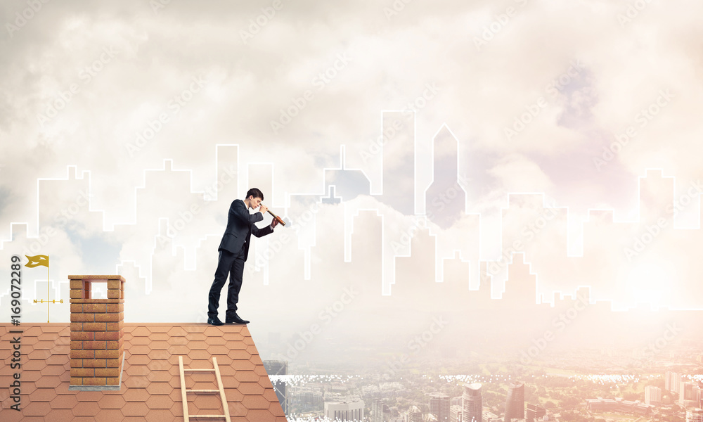 Engineer man standing on roof and looking in spyglass. Mixed med Engineer man standing on roof and looking in spyglass. Mixed med